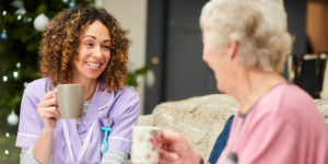 senior woman and her doctor drinking tea together